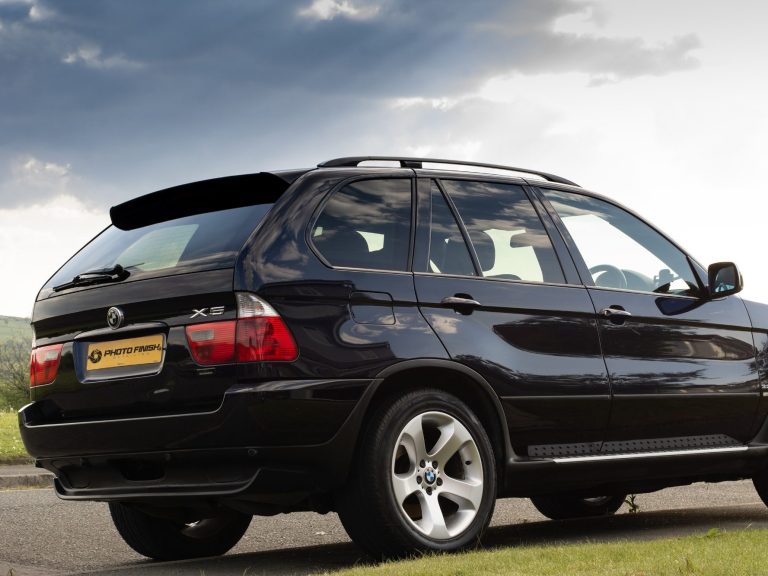 Dark blue BMW X5 looking clean in the sun after receiving a Photo Finish valet and detail.