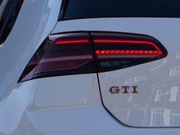 White Volkswagen Golf GTI with LED rear light.