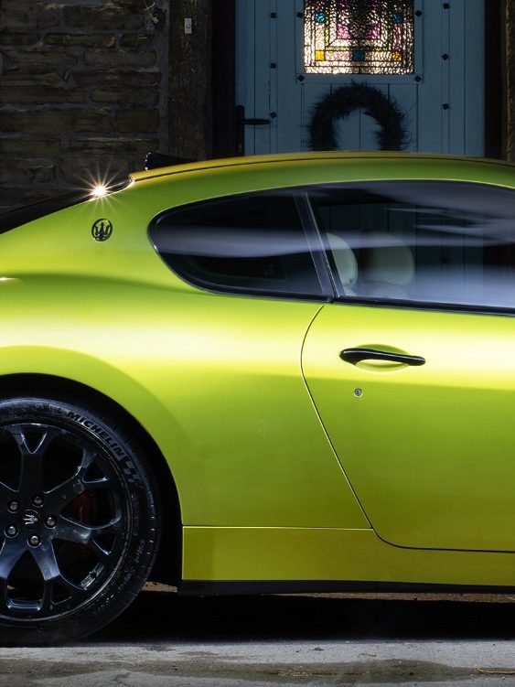 Nicely lit lime green Maserati side view in the dark after a full detail